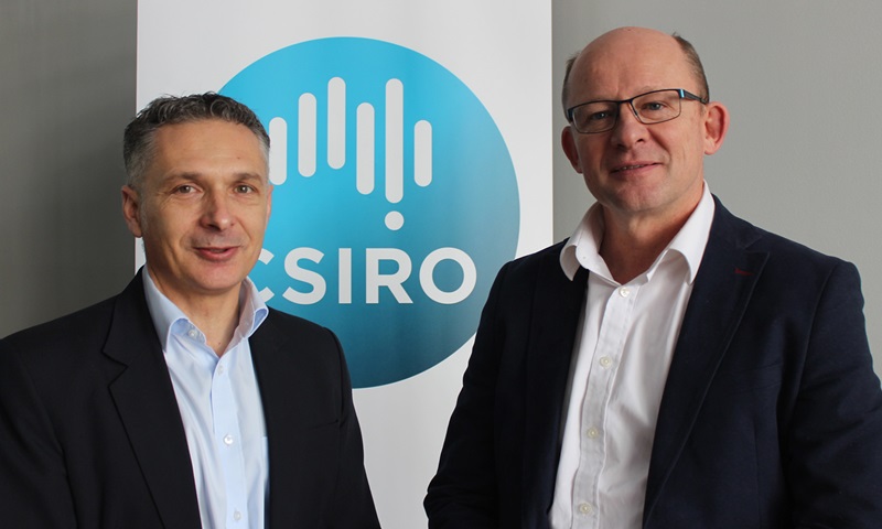 Two men standing infront of banner with CSIRO logo 