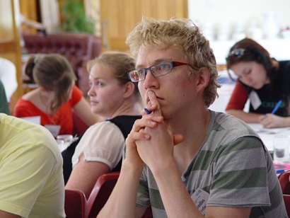 Close up of a person in a focus group listening to information being delivered by social researcher