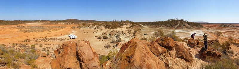 outback landscape with car and two field geologists