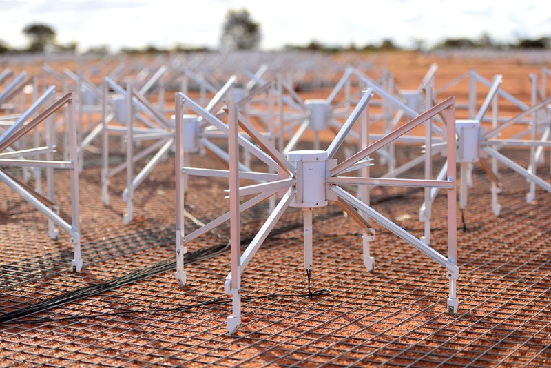 Small, spider-like antennas sit across red earth.