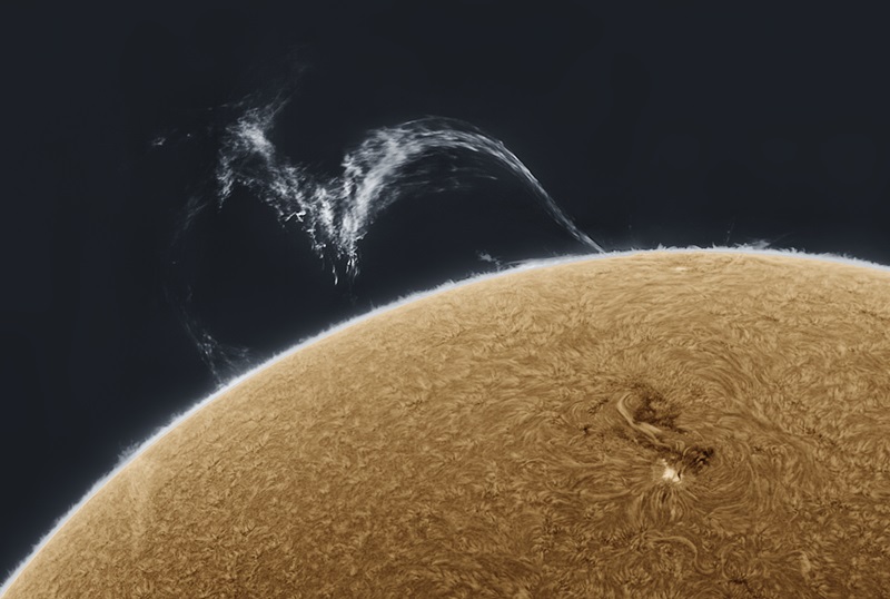 a large filamentary prominence at the moment of detachment, as two of its three feet separated from the Sun’s surface. A segment of the Sun can be seen taking up the lower half of the image.  Blobs of plasma rained down towards the Sun in the middle segment, and the right side of the filament was sucked back towards its root, while the top reached about 225,000km towards space. 