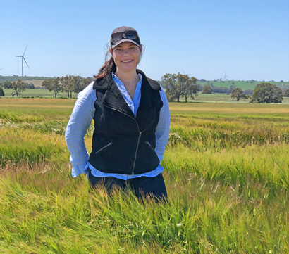 iPhD researcher standing in a barley field 