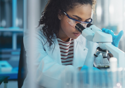 Student working in a lab with a microscope