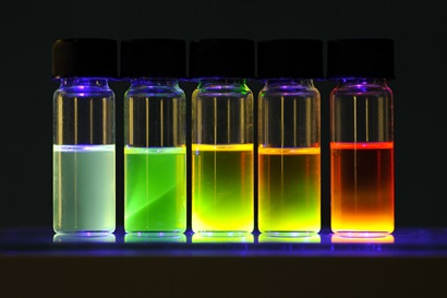 Photo of lidded glass jars on a bench containing different coloured liquids