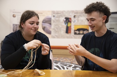 Students participating in a weaving circle