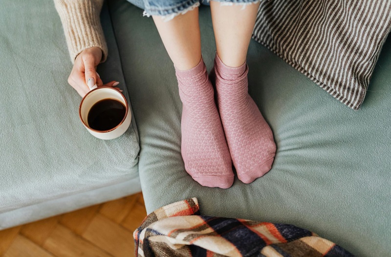 View of a person's feet who is trying to stay warm at home