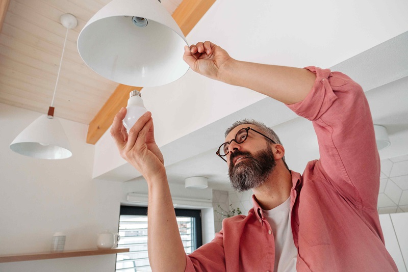 Photo of a man replacing a light bulb