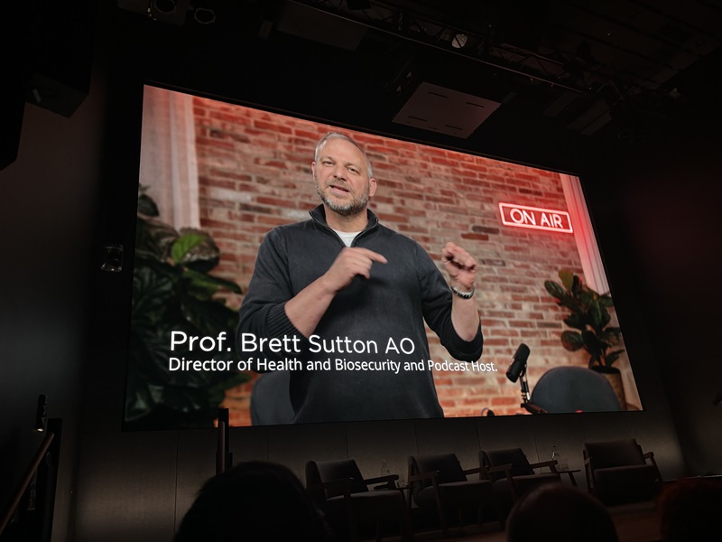 Man on a screen in an auditorium