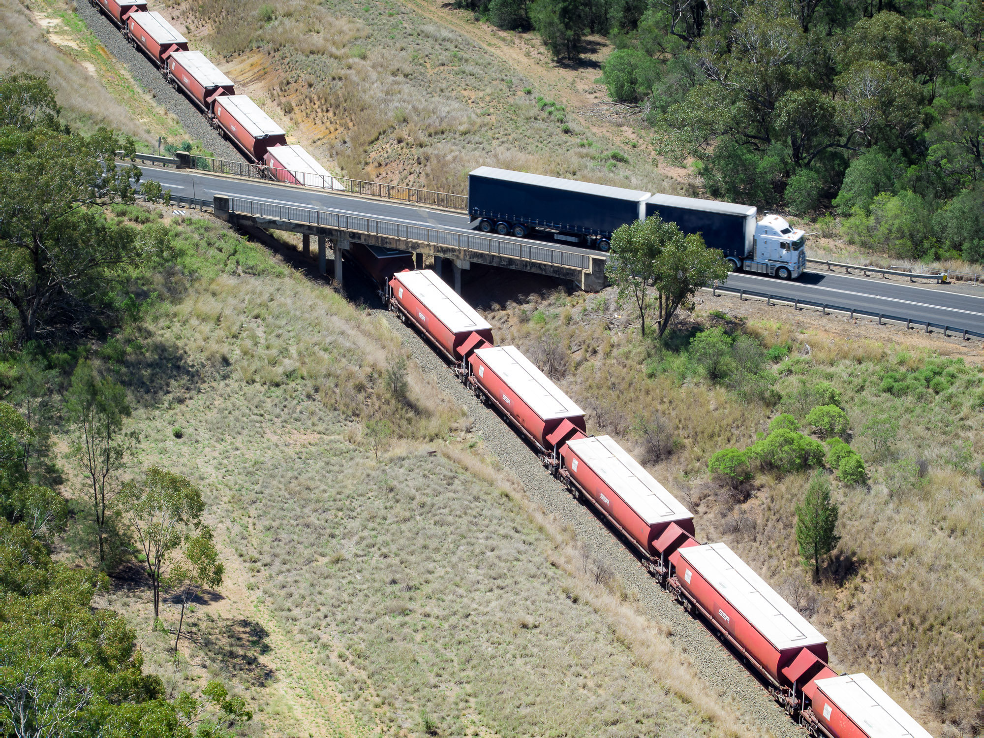 Truck on road crossing over train line