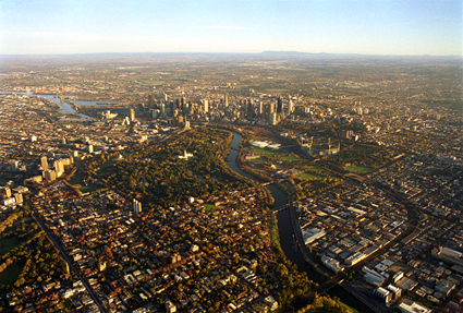 Overhead shot of Melbourne CBD, Yarra River, urban parkland and suburbs
