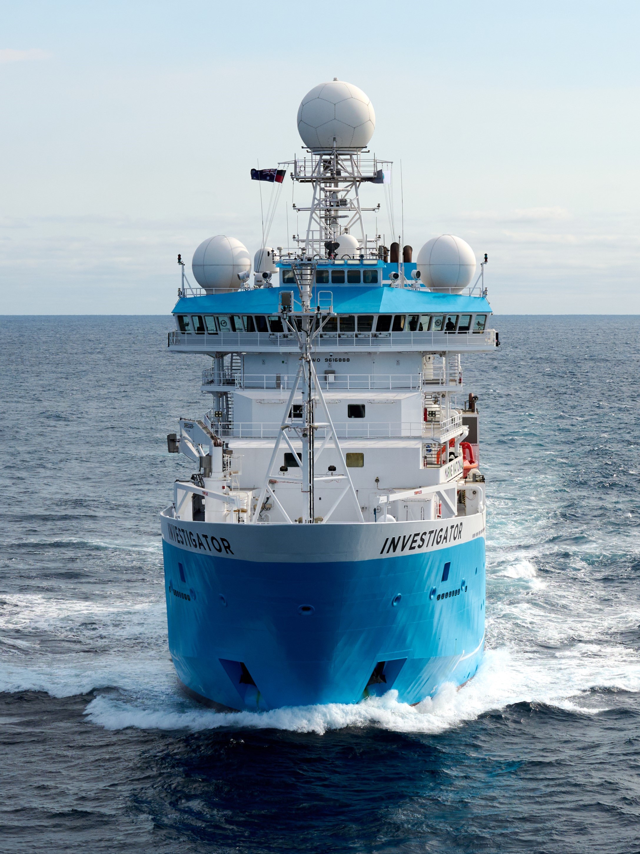 A large blue and white ship on the ocean.