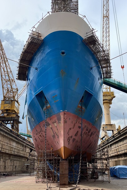 A large red, blue and white shit in a dry dock.