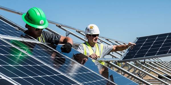 Two men installing solar panels