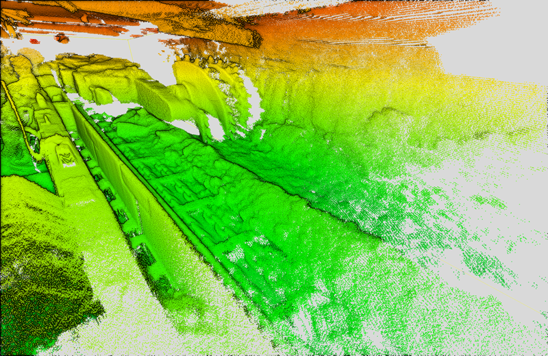 Graduated orange, yellow and green coloured scan detailing tunnel which shows coal shearer working along an undergroung coal longwall