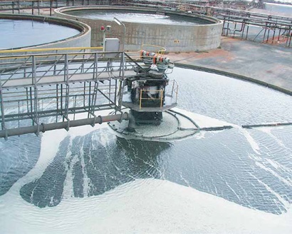 large outdoor gravity tank filled with swirling liquid