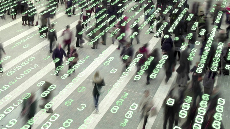 Binary code supercomposed over people walking in busy city street. 