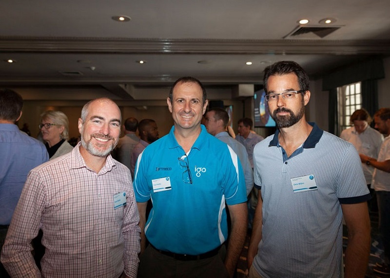 two men smiling with bearded man 