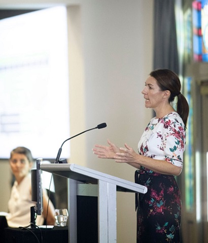 Female speaker at lecturn