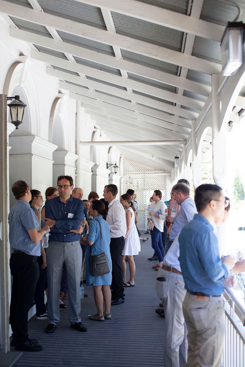 gathering of people standnng on an open terrace balcony 