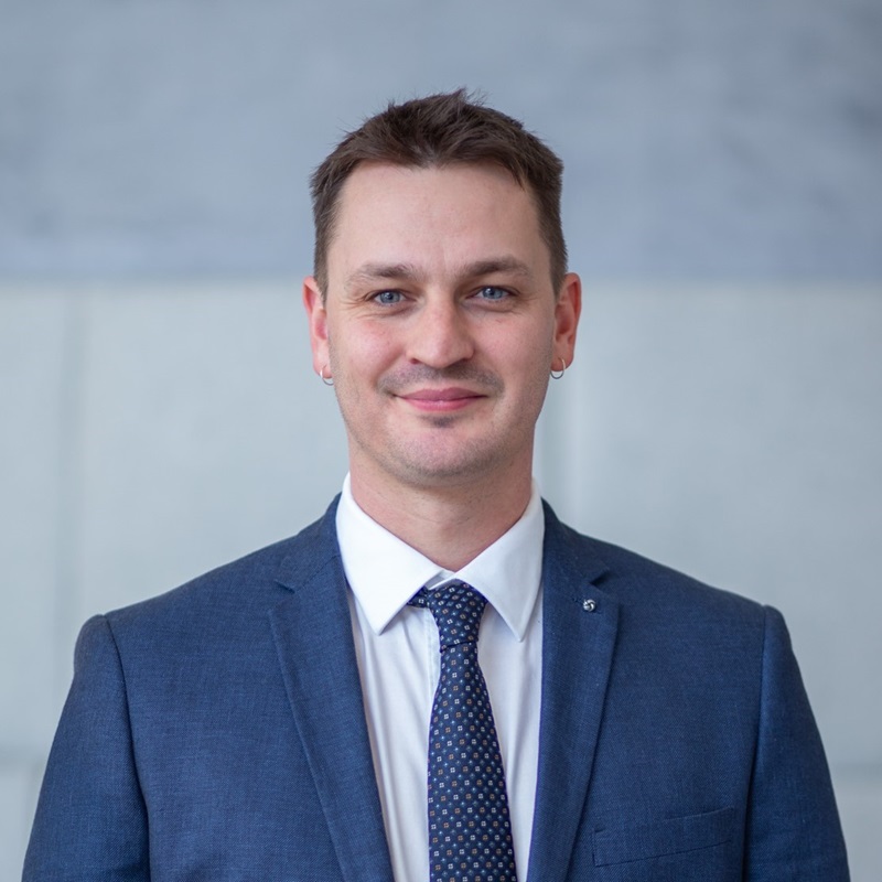 Man wearing blue suit and tie 