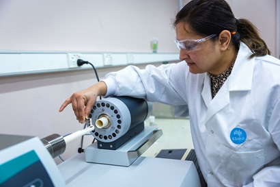 Female researcher using a scientific machine