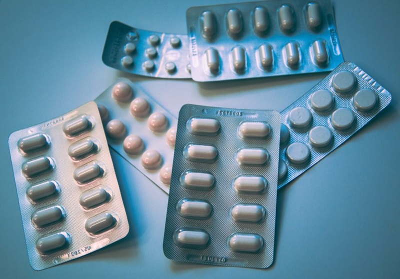 Anti-malarial drugs in packets arranged on a table.