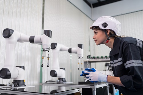 Female engineer training an AI powered robot.