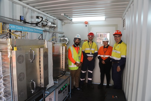 Sarb Giddey (CSIRO), Chris Rowland (Hadean Energy) Gurpreet Kaur (CSIRO) and Shannon Ballard (BlueScope) with the SOE electrolyser at BlueScope’s Port Kembla steel plant.