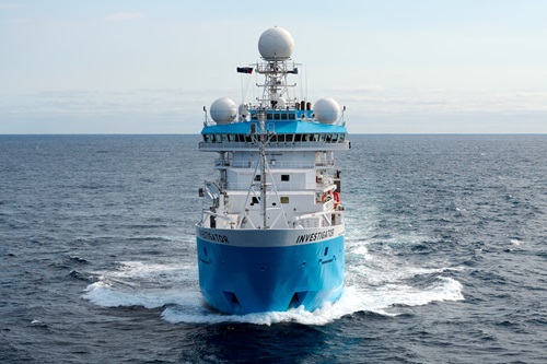 A blue and white ship at sea.