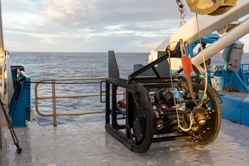 A piece of scientific equipment on the deck of a ship at sea.