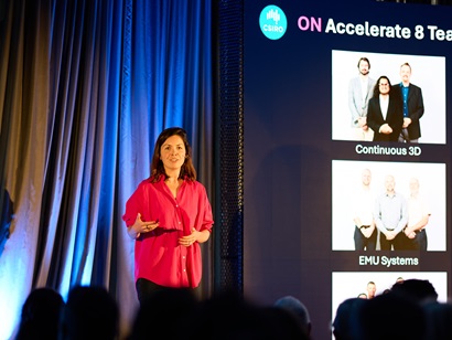 A woman delivering a presentation at a conference, showcasing her knowledge to an attentive audience.