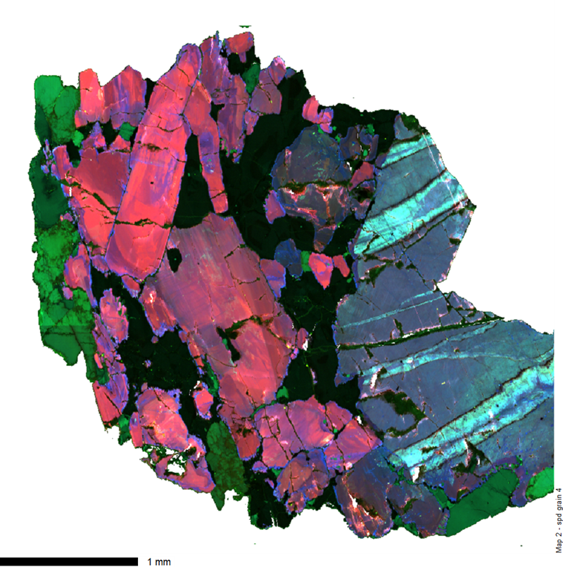 a coloured image (red to green to blue) of a mineral structure showing different grains interlocking. The measurement on the image shows a scale of 1mm, indicating that the sample is about 4 mm across.