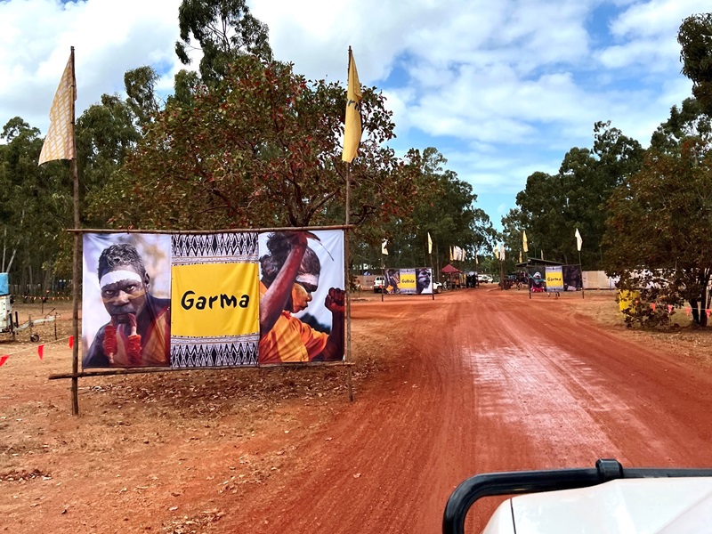 A large banner with the word "Garma" and images of two Indigenous people, marking the entrance to the Garma Festival.