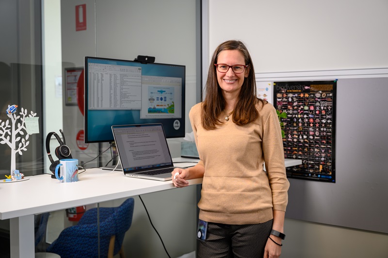 A person standing up in an office setting.