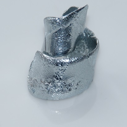 a silvery metal in a swirl shape, like a pencil shaving.