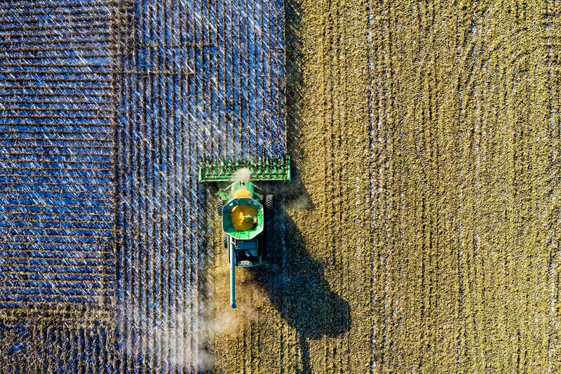 Tractor fertilising a field.