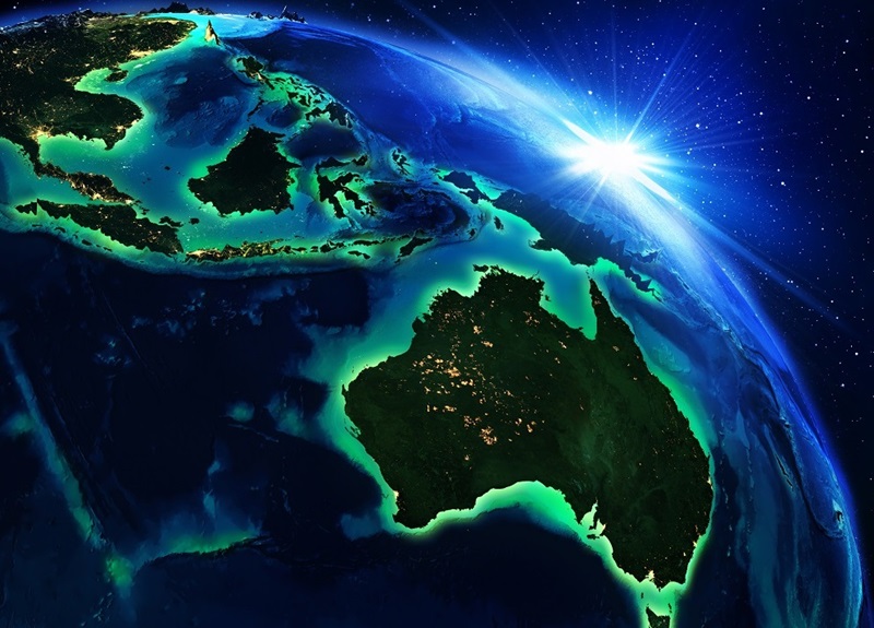 A stylised view of the Earth showing Australia. Stylised sun rays can be seen glinting off the edge of the globe