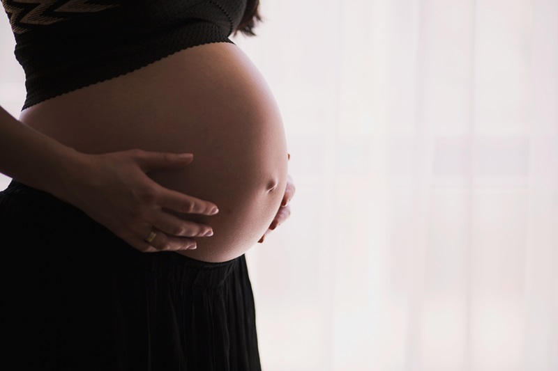 A close-up of a pregnant person's belly