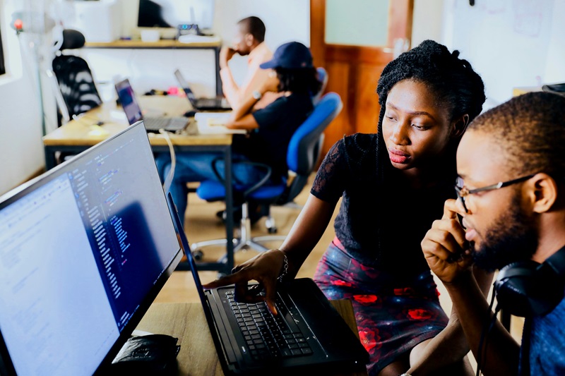 Two people looking at a computer together