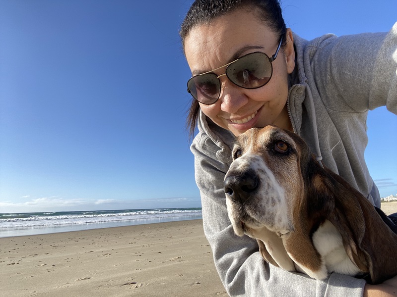 Louisa on the beach with her Basset Hound