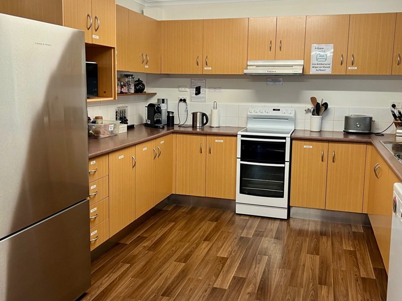 A kitchen with many different decorations, appliances, and wooden features.