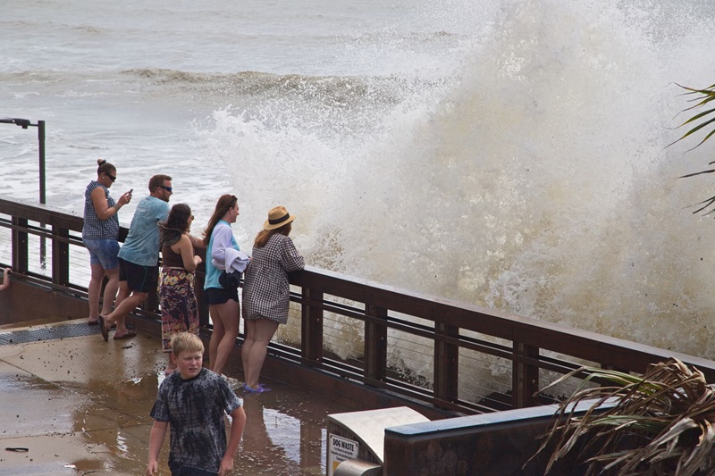 People watching the waves crashing over the beachfront at high tide while Tropical Cyclone Alfred is offshore in Yeppoon Queensland Australia, March 1, 2025. Image by Shutterstock.