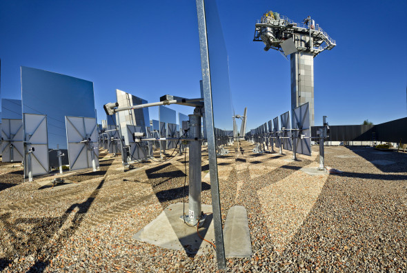 An array of mirrors in front of a tower